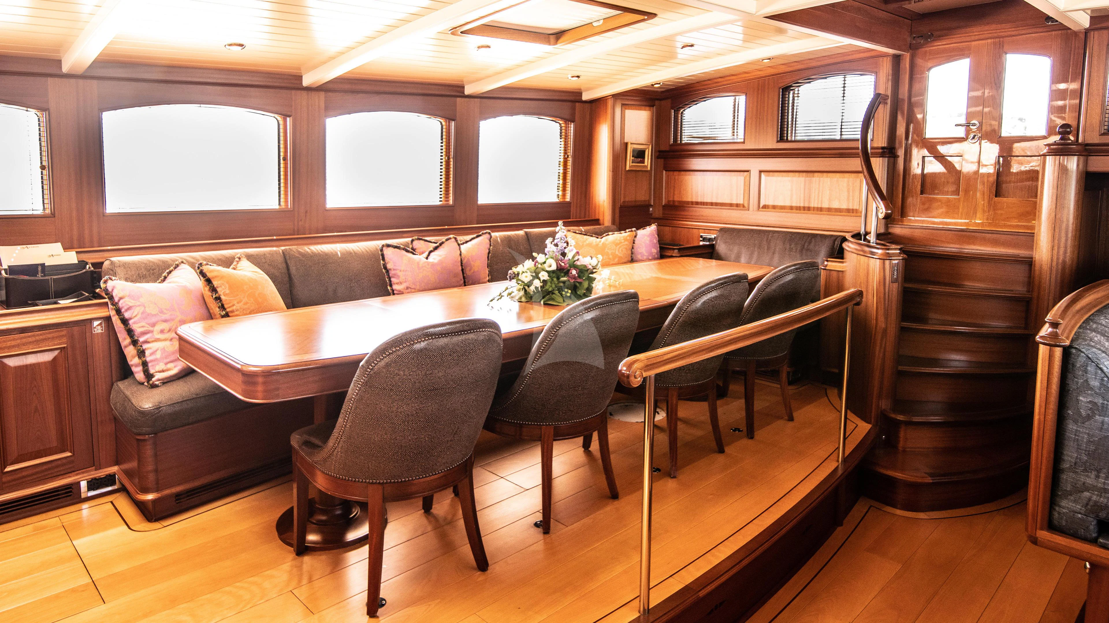 a living room with a couch and a table aboard ATHOS Yacht for Sale