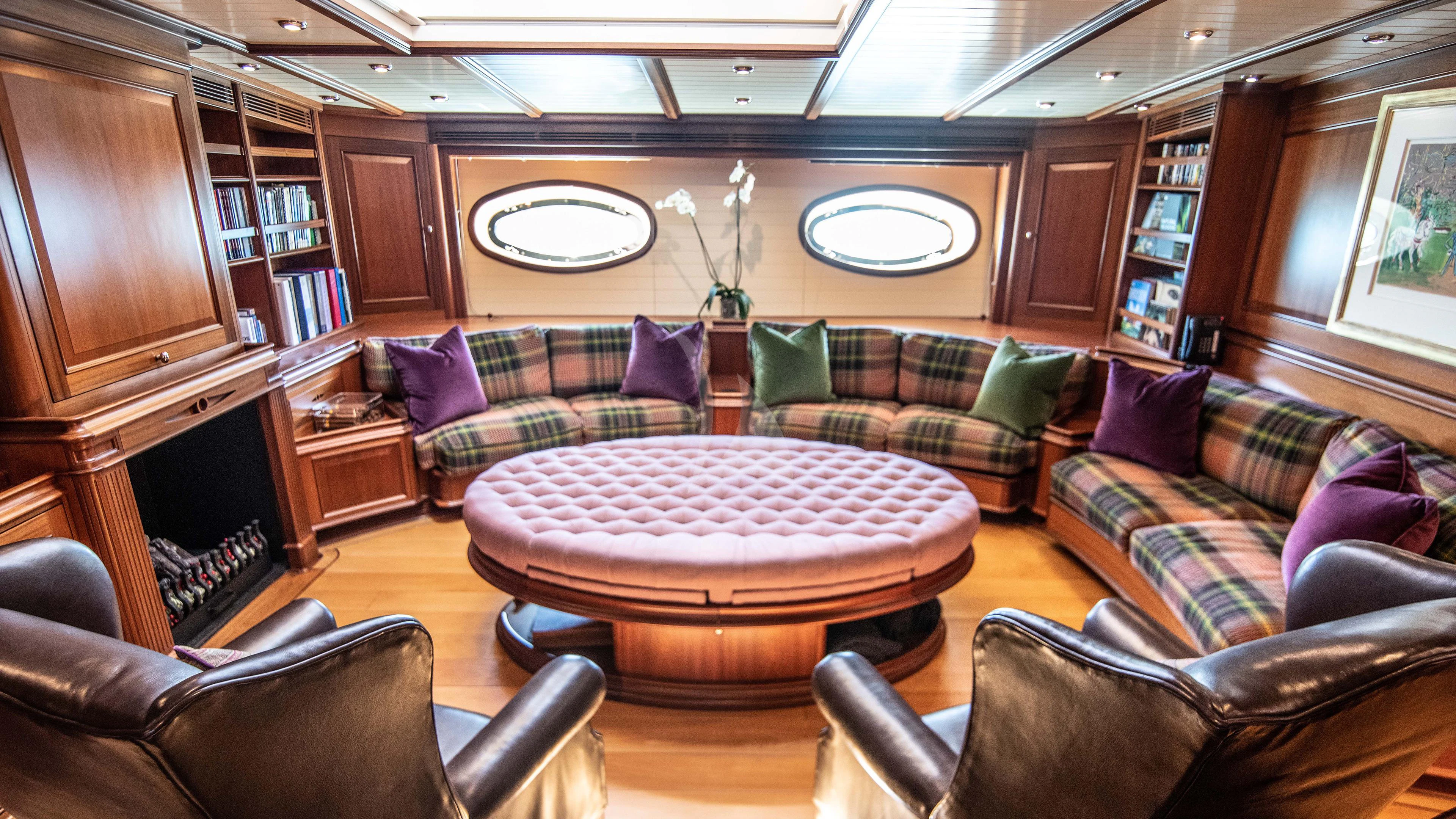 a living room with a couch and a table aboard ATHOS Yacht for Sale