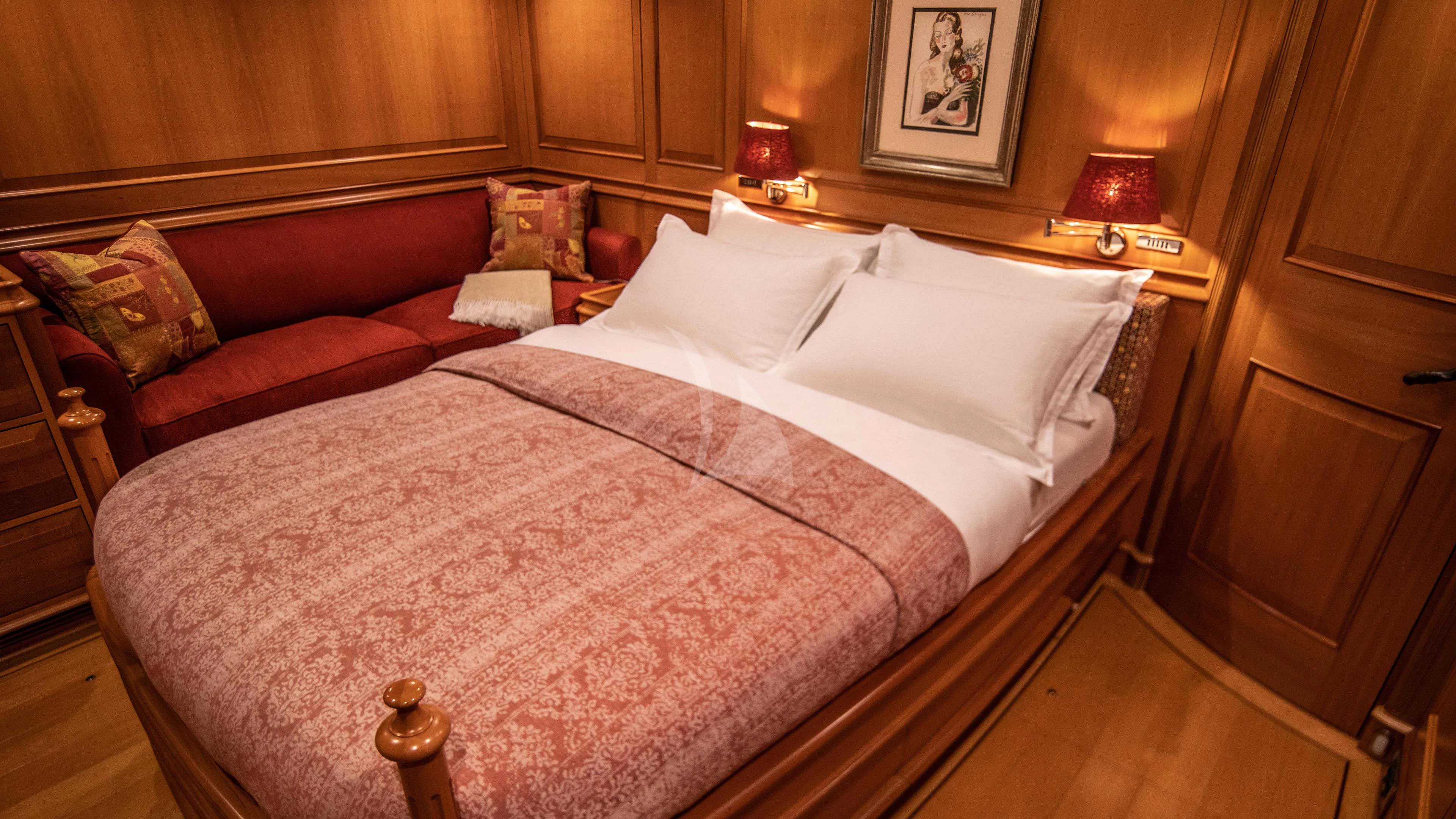 a bed with a pink comforter aboard ATHOS Yacht for Sale