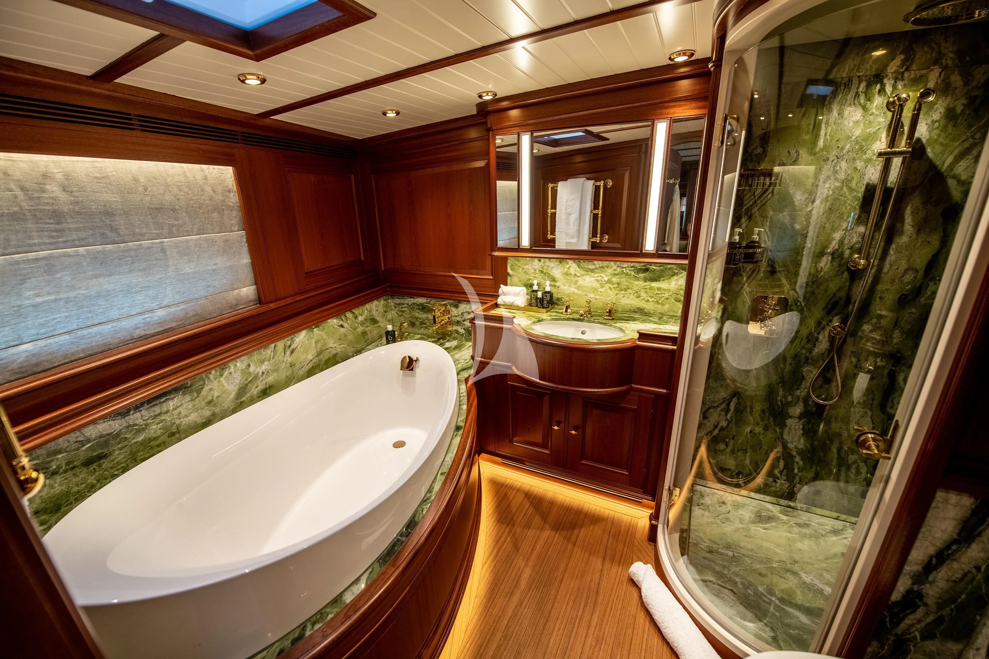 a bathroom with a tub and shower aboard ATHOS Yacht for Sale