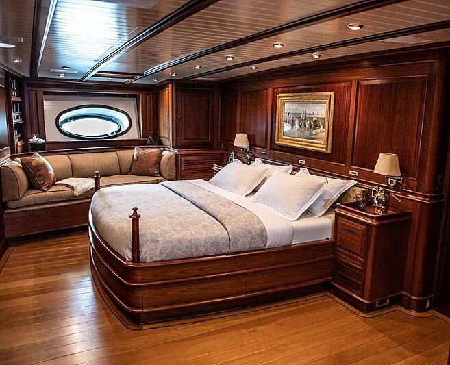 a large bed in a room aboard ATHOS Yacht for Sale