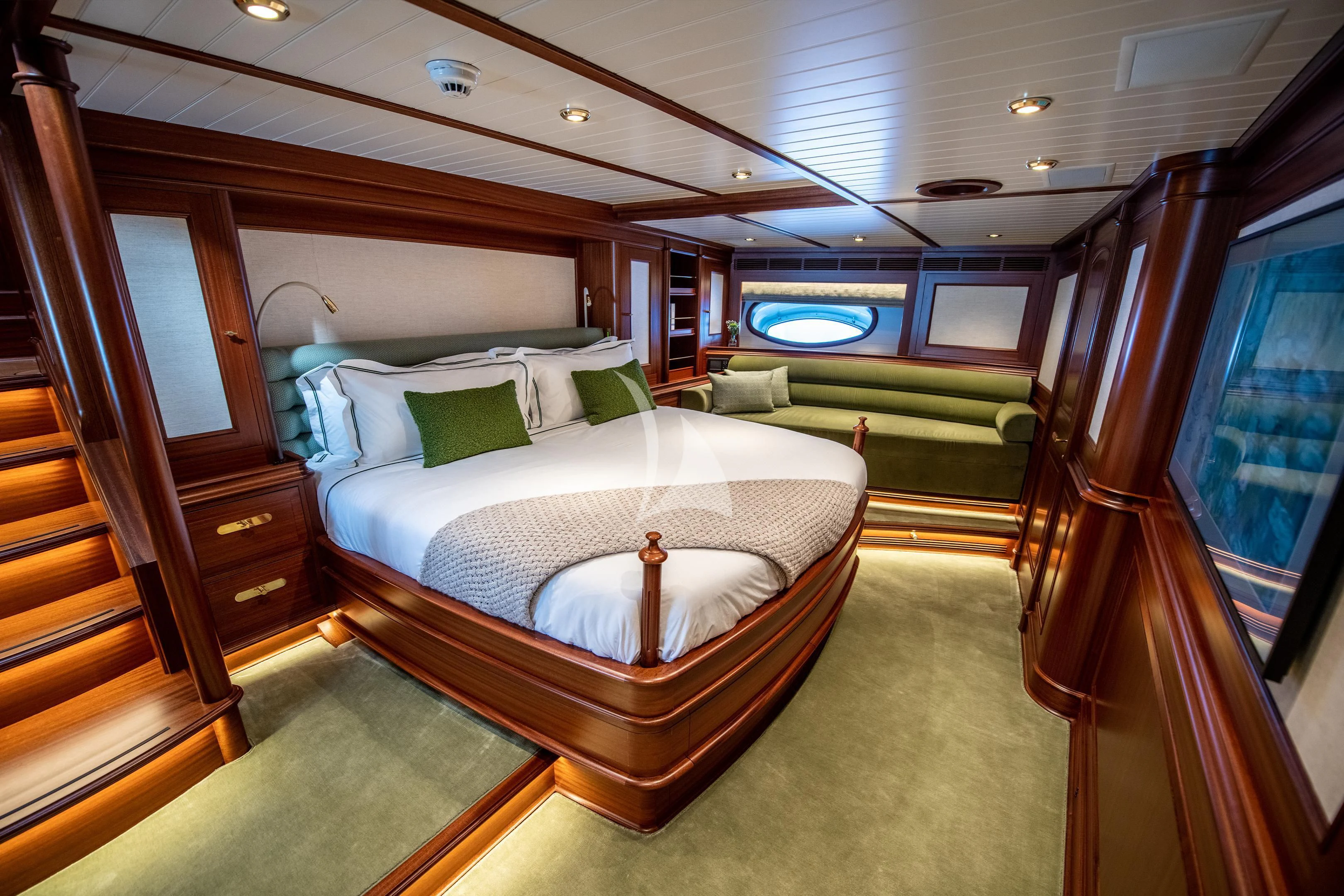 a bedroom with a bed and a wood door aboard ATHOS Yacht for Sale