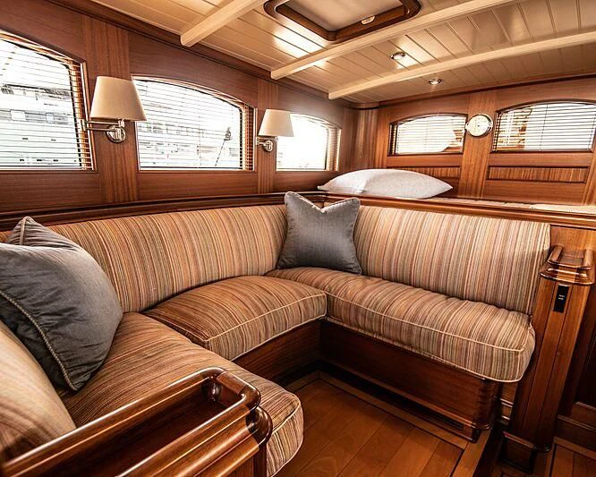 a couch in a room aboard ATHOS Yacht for Sale