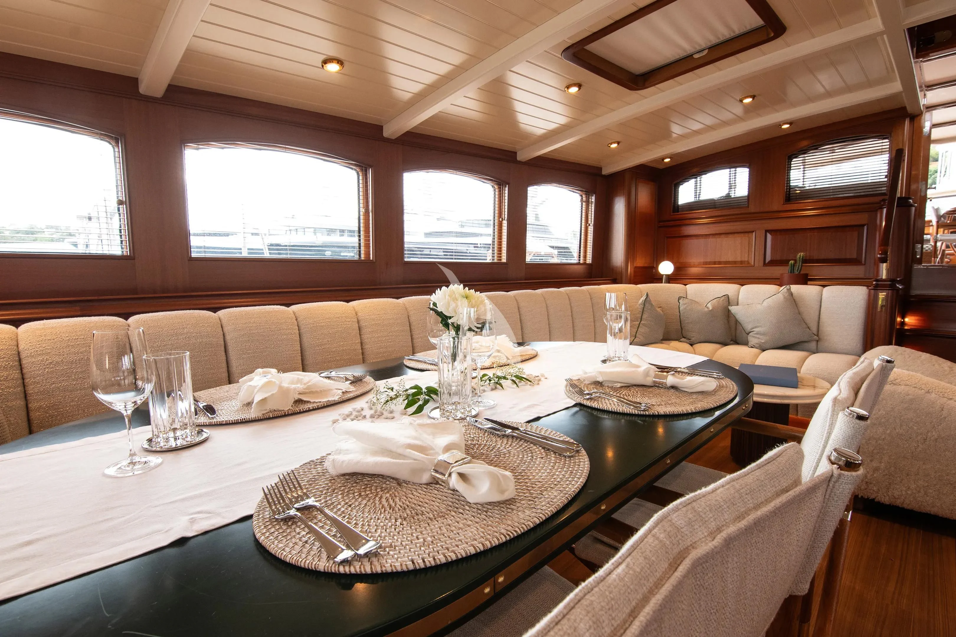 a dining table with a plate and chairs aboard ATHOS Yacht for Sale