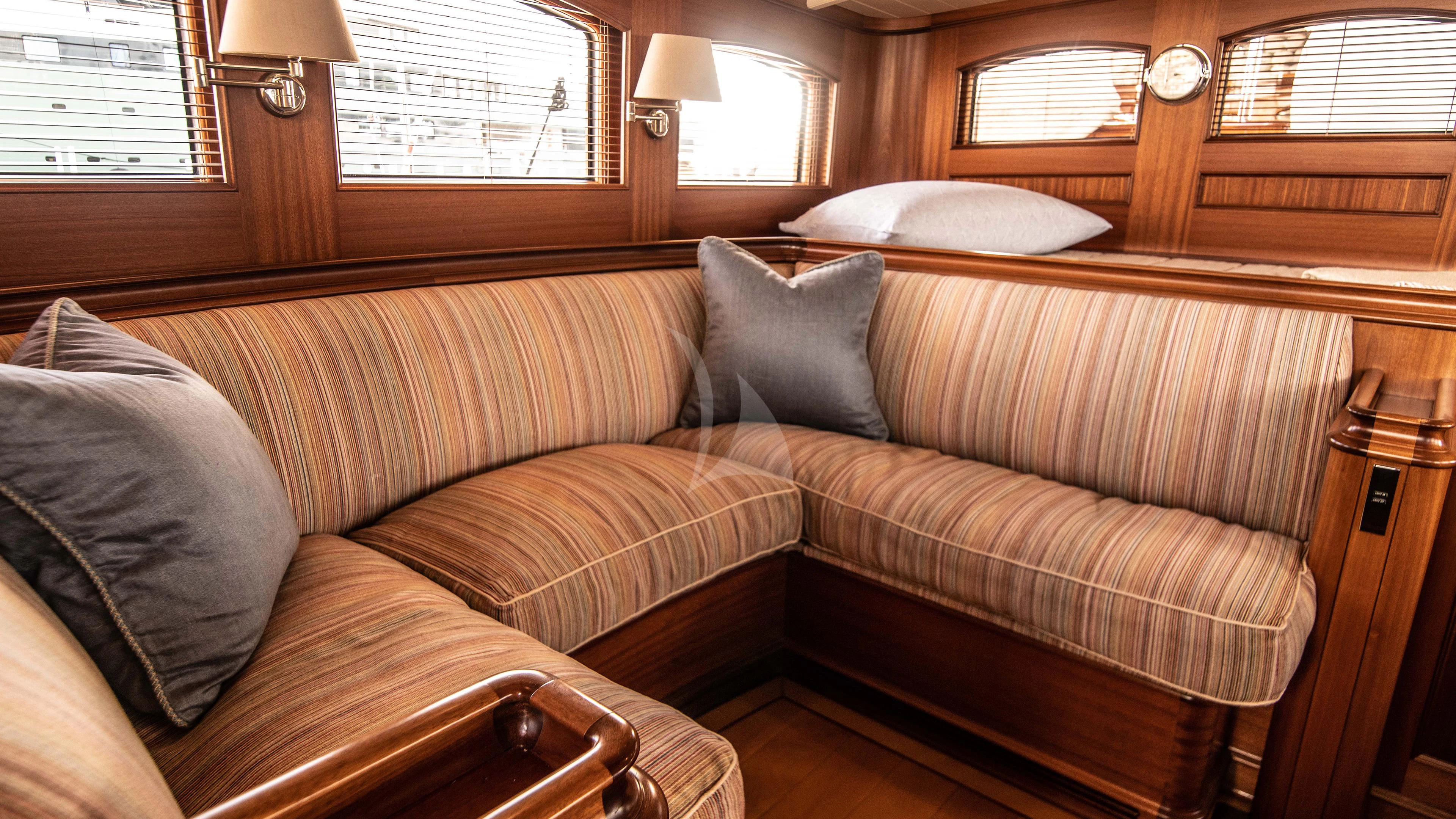 a couch in a room aboard ATHOS Yacht for Sale