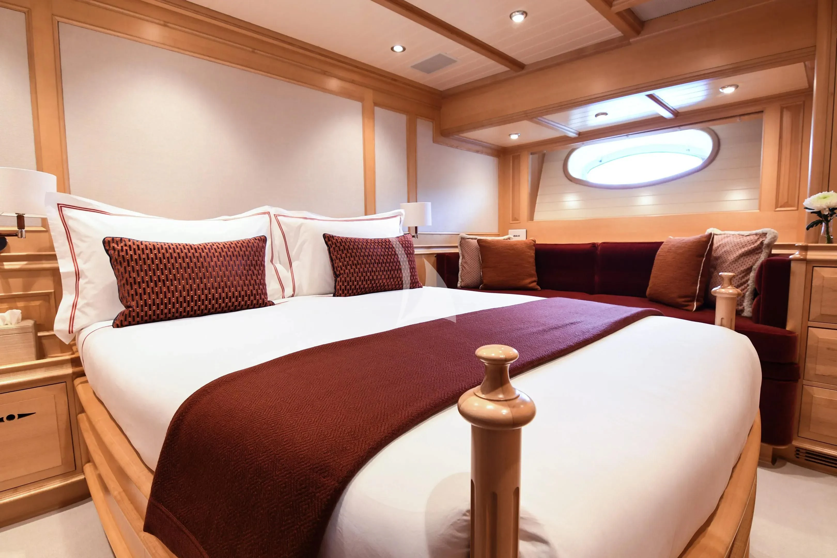 a bed with a white bed spread aboard ATHOS Yacht for Sale