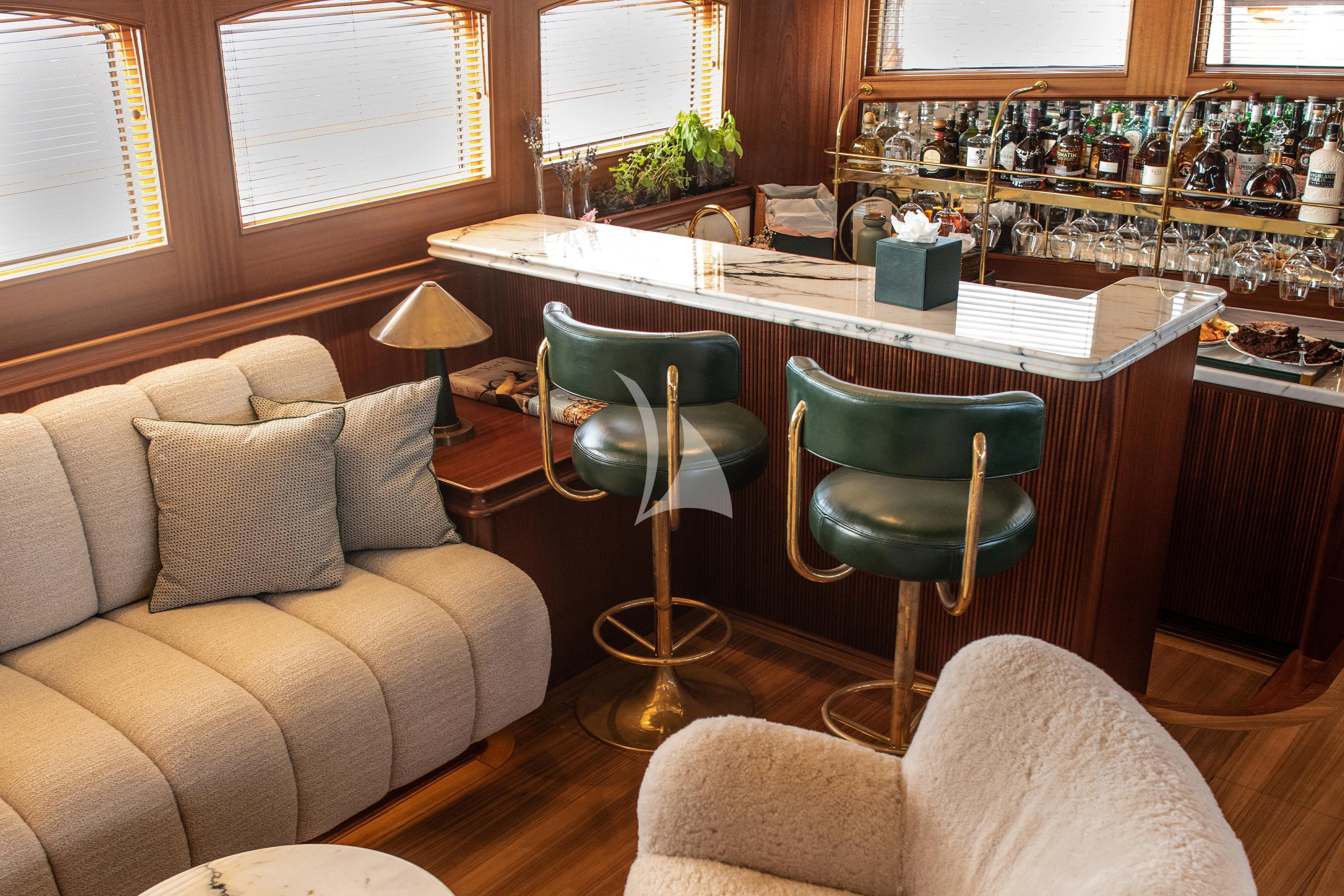 a living room with a desk and chairs aboard ATHOS Yacht for Sale