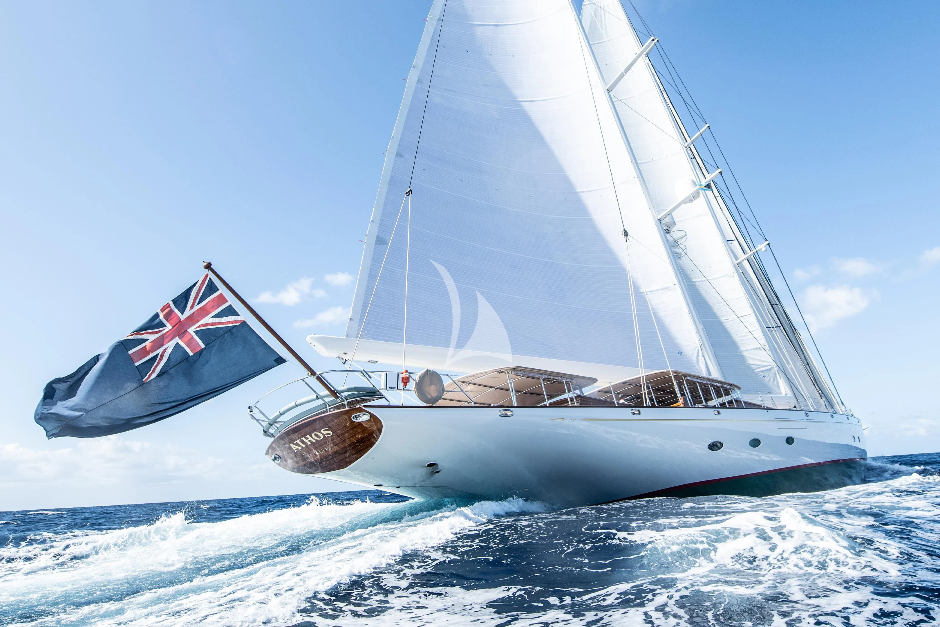 a boat with a flag on it aboard ATHOS Yacht for Sale