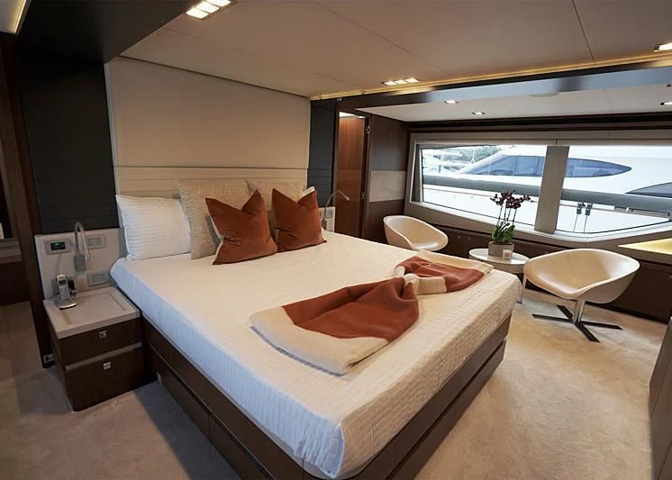 a bed with a white bed spread aboard MACQNDO Yacht for Sale