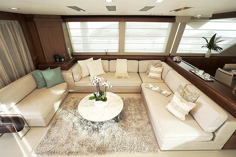 a living room with a couch and a table aboard MACQNDO Yacht for Sale