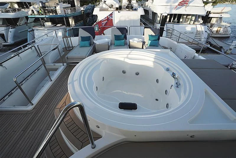 a white pool with a round white table and chairs on it aboard MACQNDO Yacht for Sale
