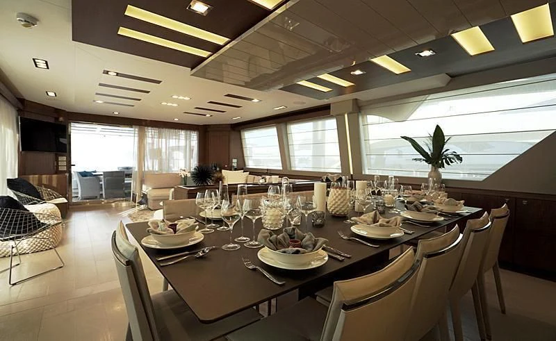 a large dining room with a large table set for dinner aboard MACQNDO Yacht for Sale