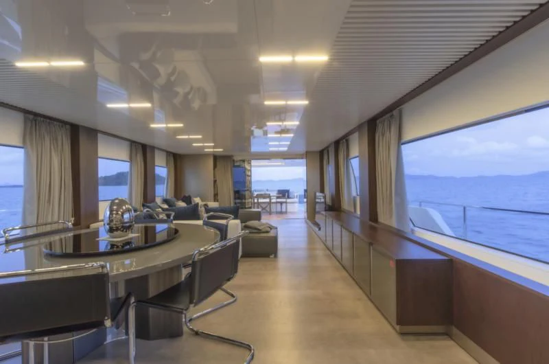 a large room with a table and chairs aboard ORIANT Yacht for Sale