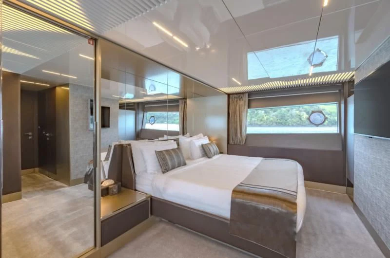 a bedroom with a bed and a window aboard ORIANT Yacht for Sale