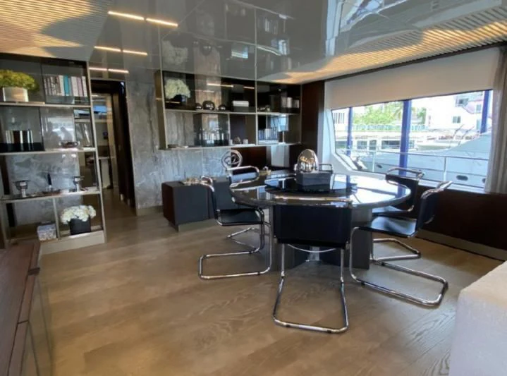 a room with a table and chairs aboard ORIANT Yacht for Sale