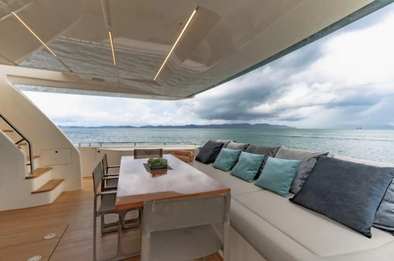 a large white tent with a table and chairs and a view of the ocean aboard ORIANT Yacht for Sale