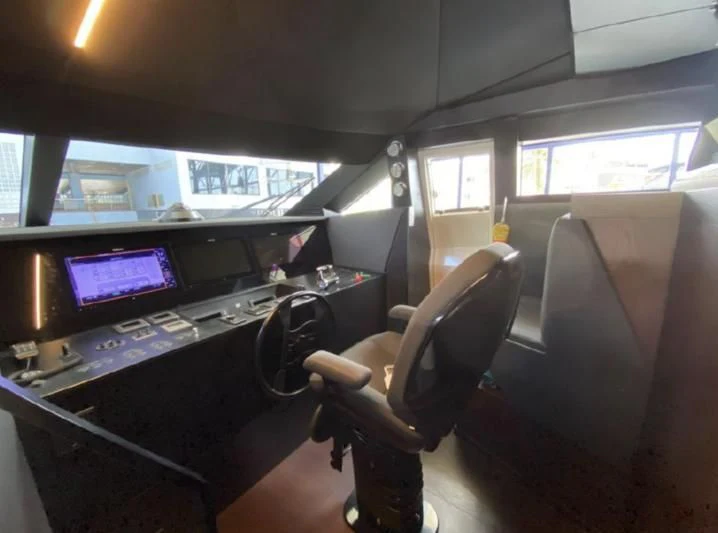 a person sitting in a chair in a control room aboard ORIANT Yacht for Sale