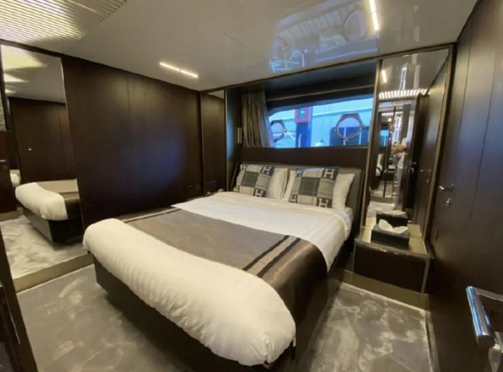 a room with a bed and a tv aboard ORIANT Yacht for Sale