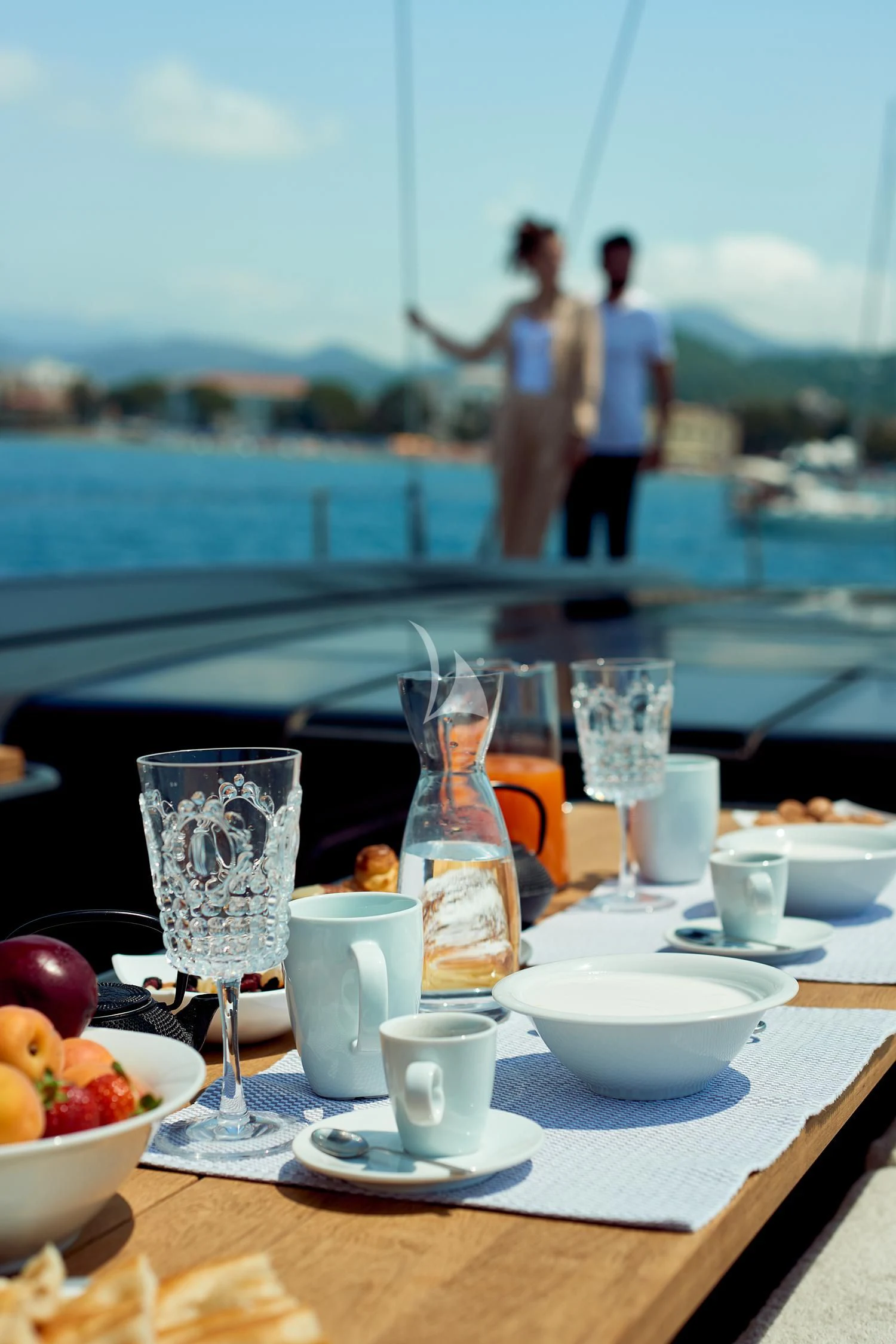 a table with glasses and food on it aboard AORI Yacht for Sale