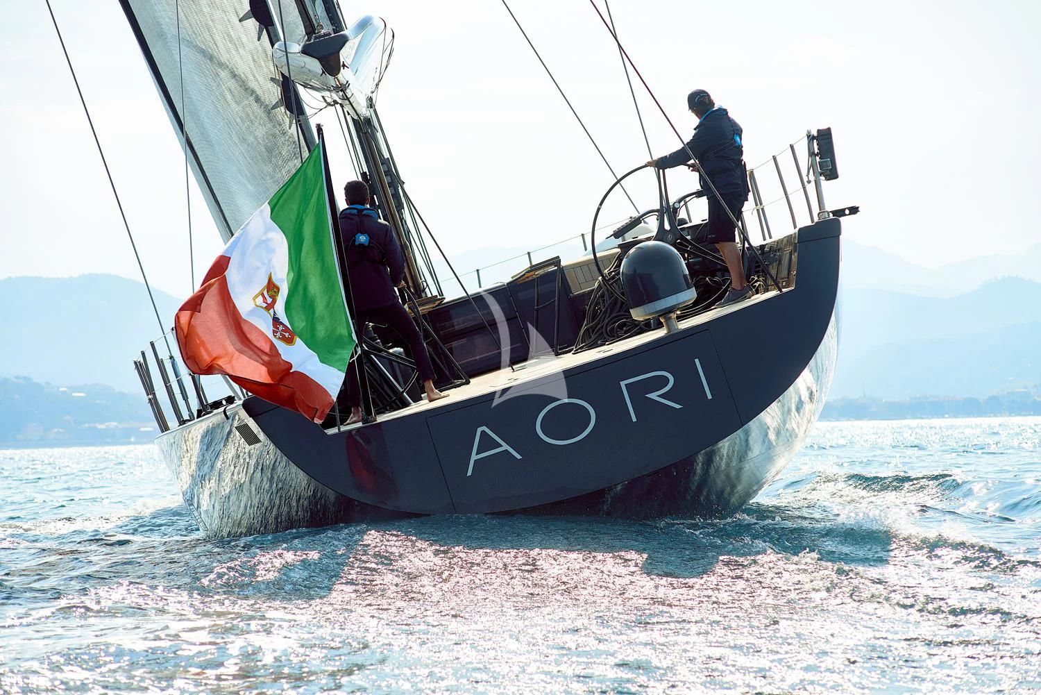 a boat with a flag on it aboard AORI Yacht for Sale