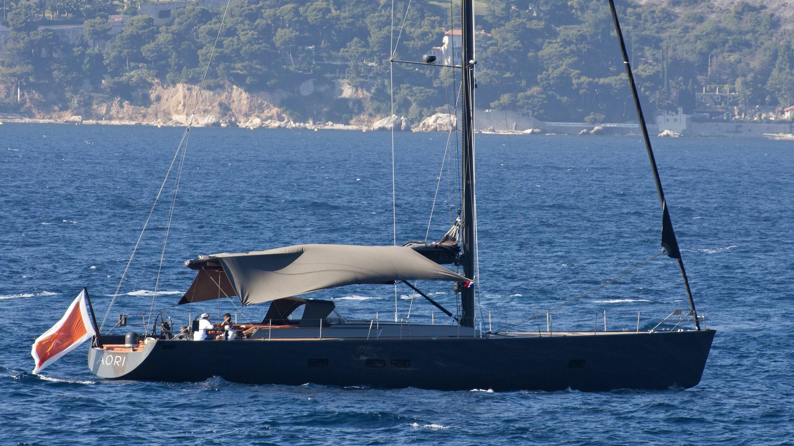 a boat with a flag on it aboard AORI Yacht for Sale