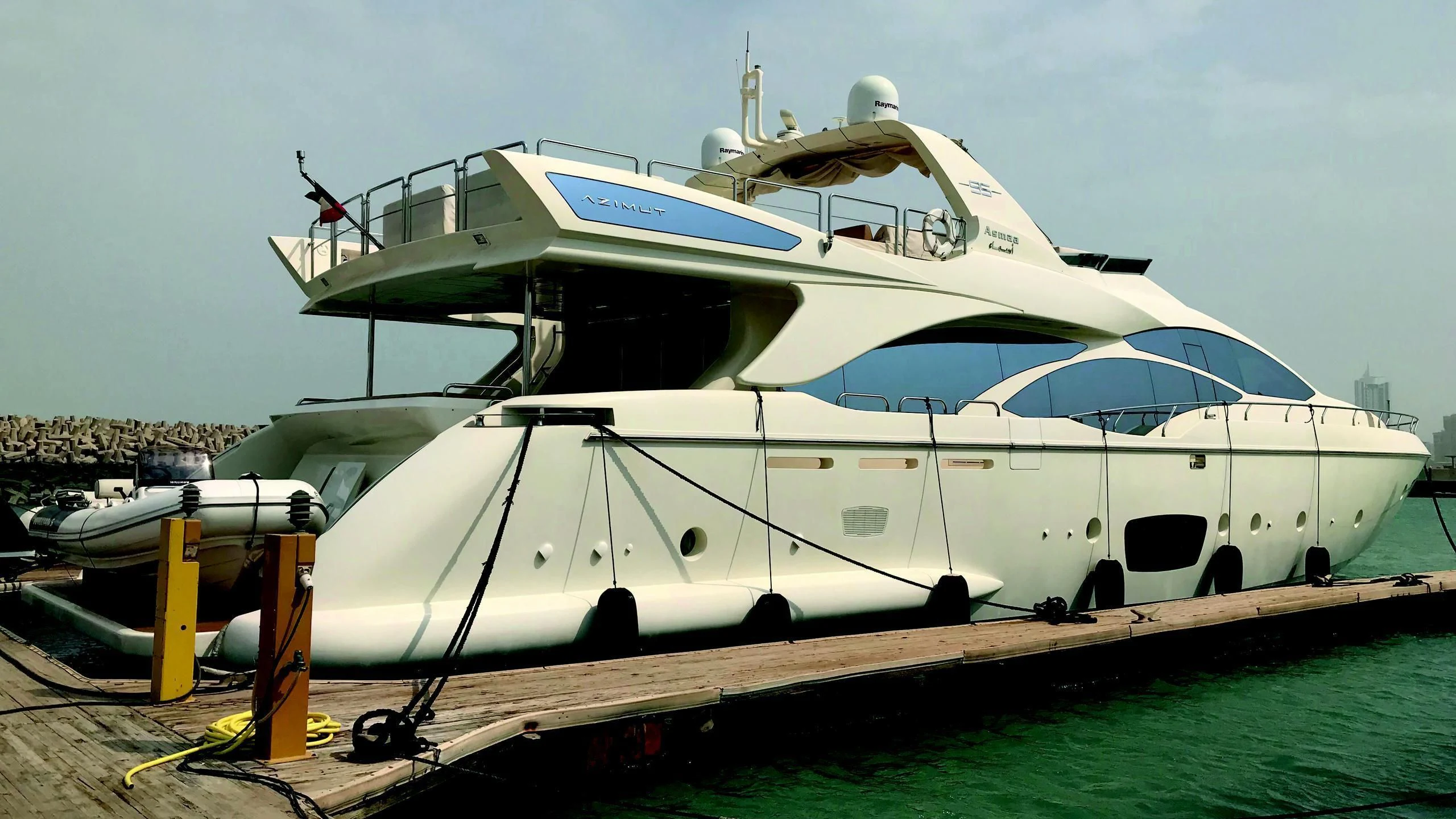 a white boat on a dock aboard ASMAA Yacht for Sale