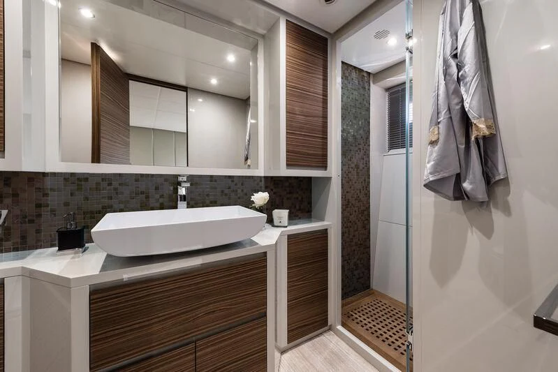 a bathroom with a large mirror aboard REBELOTT Yacht for Sale