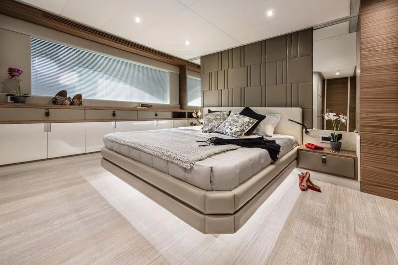 a large bedroom with a large bed aboard REBELOTT Yacht for Sale