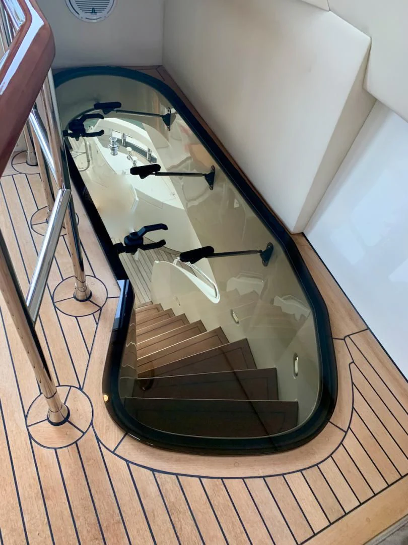 a white toilet with a wooden floor aboard QUEEN MARA Yacht for Sale