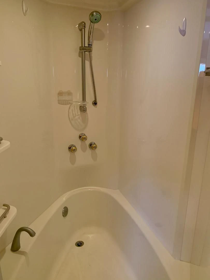 a bathtub with a shower head aboard QUEEN MARA Yacht for Sale