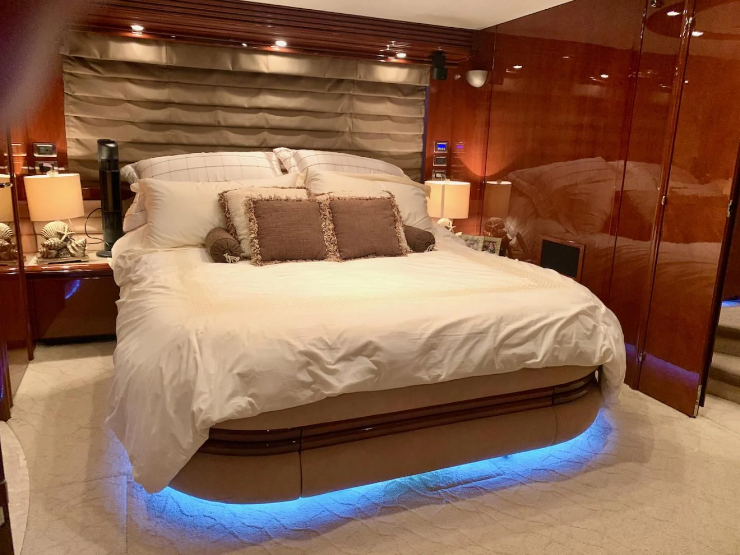 a bed with a white comforter aboard QUEEN MARA Yacht for Sale