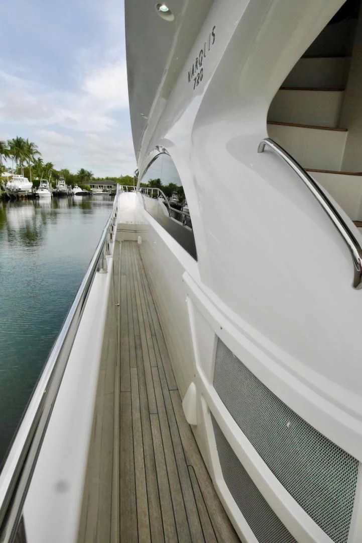 a long wooden walkway next to a body of water aboard QUEEN MARA Yacht for Sale