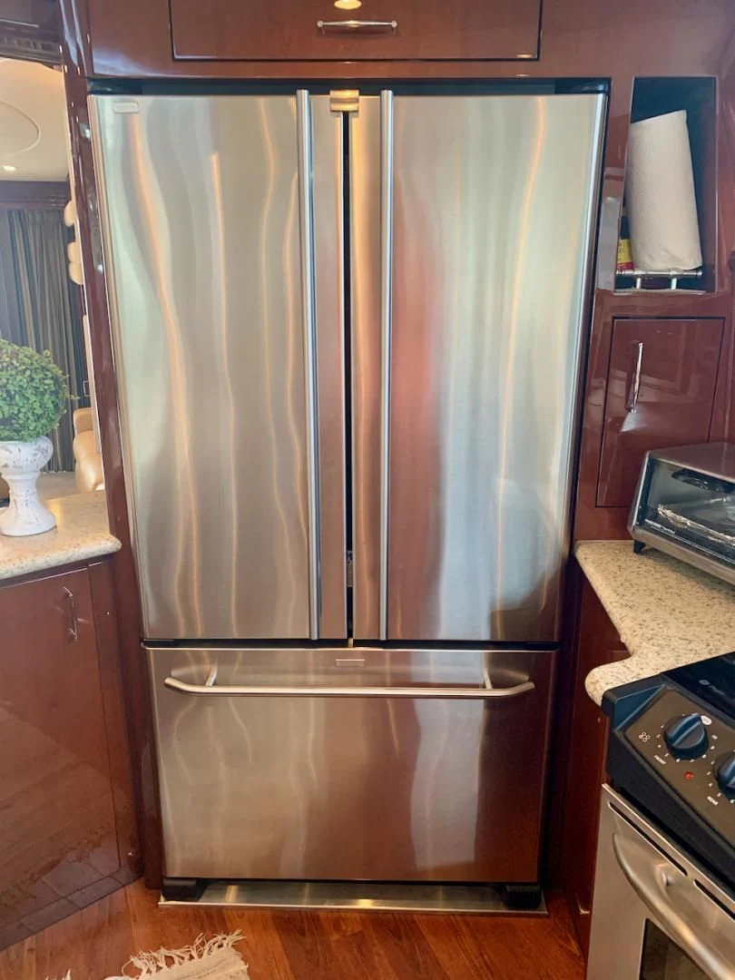 a stainless steel refrigerator in a kitchen aboard QUEEN MARA Yacht for Sale