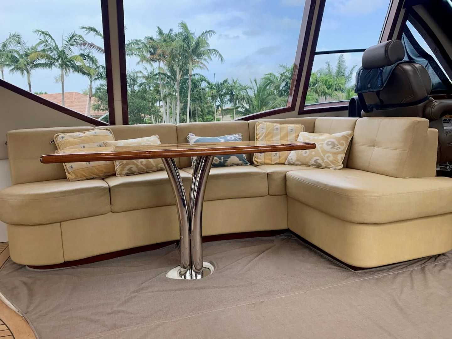 a couch and a table in a room with a window aboard QUEEN MARA Yacht for Sale