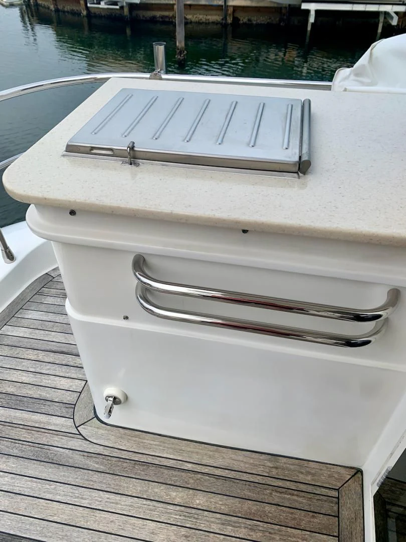 a white piano on a wooden deck aboard QUEEN MARA Yacht for Sale