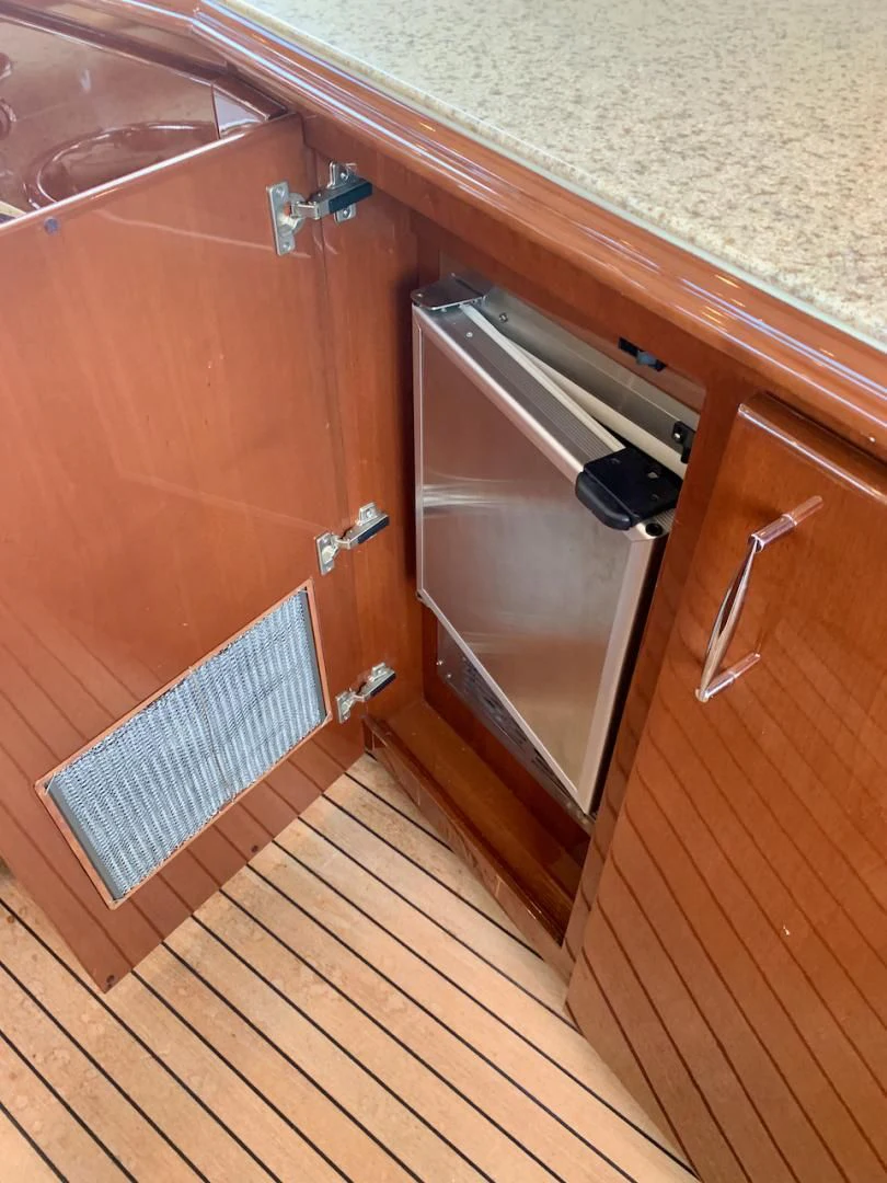 a kitchen with a wood cabinet aboard QUEEN MARA Yacht for Sale
