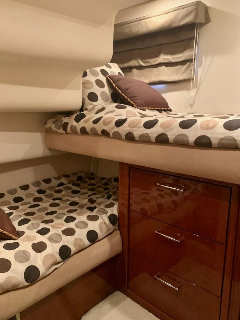 a bed with white and black pillows aboard QUEEN MARA Yacht for Sale