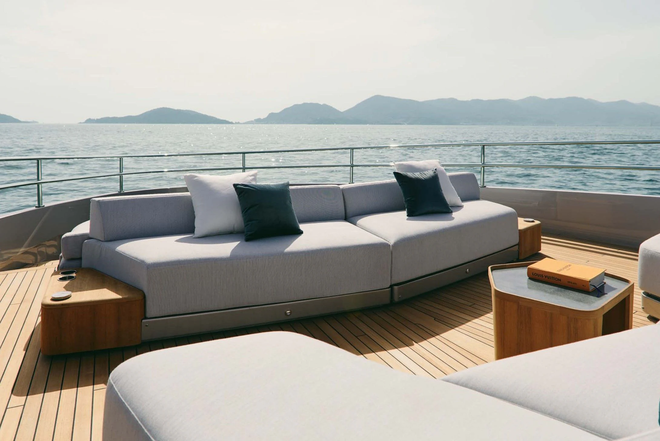 a white couch with pillows on a deck overlooking a body of water aboard AZIMUT MAGELLANO 30 Yacht for Sale