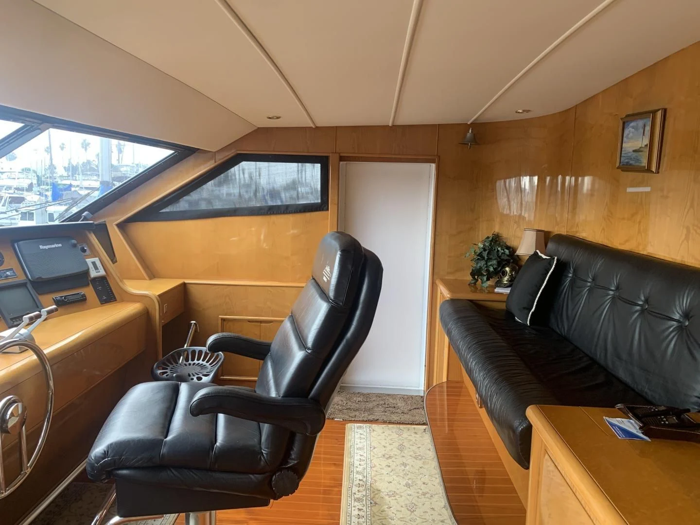 a living room with a leather couch and a tv aboard REHAB Yacht for Sale