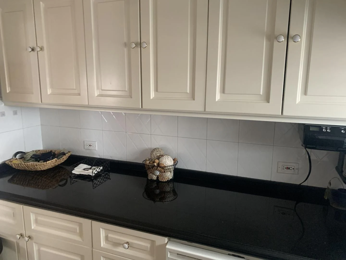 a kitchen counter with white cabinets aboard REHAB Yacht for Sale