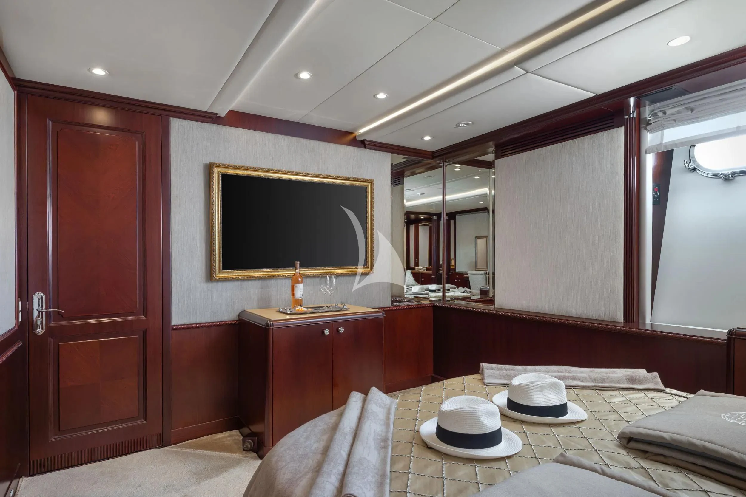 a hotel room with a tv on the wall aboard AKIRA ONE Yacht for Charter