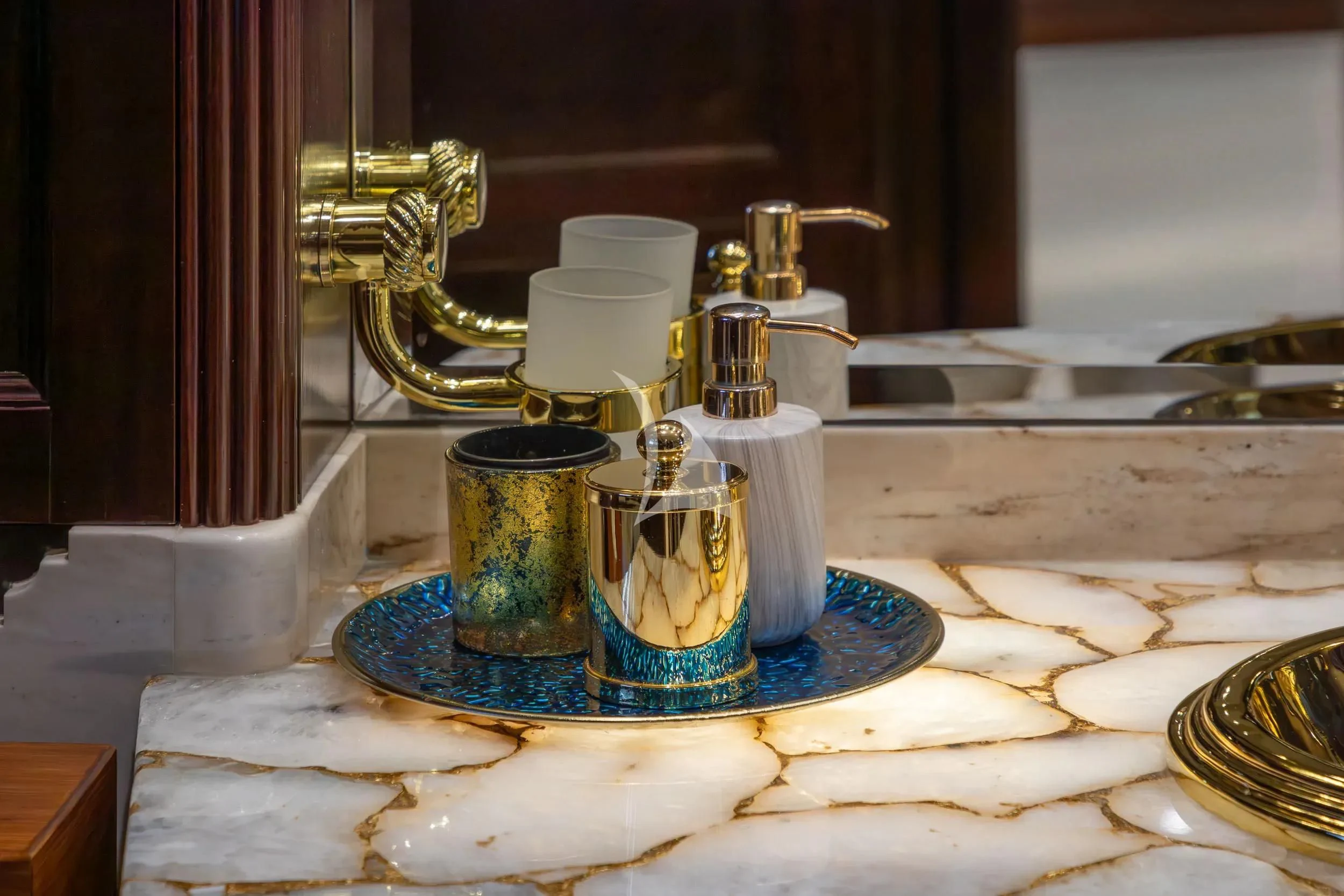a gold and silver faucet on a counter aboard AKIRA ONE Yacht for Charter