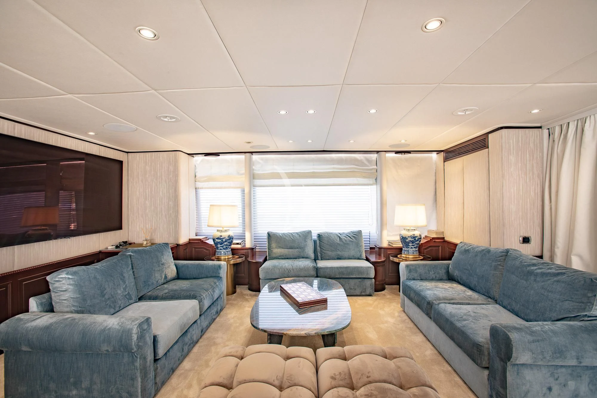 a living room with a couch and a television aboard AKIRA ONE Yacht for Charter