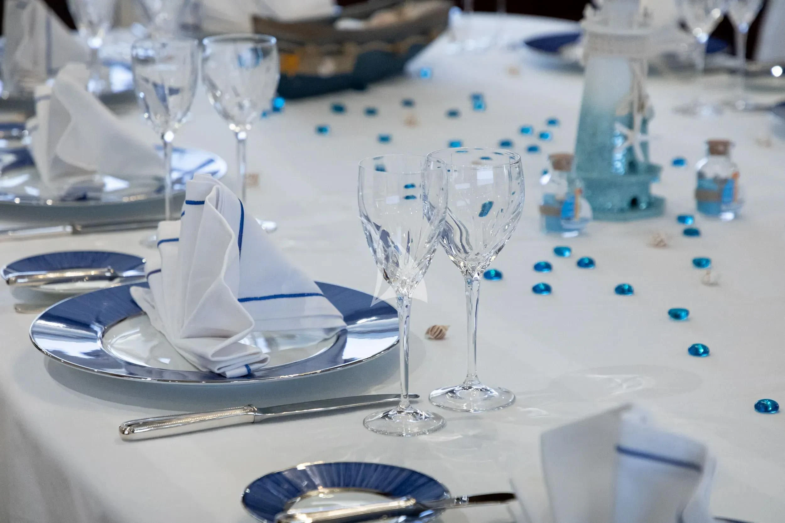 a table with empty wine glasses aboard AKIRA ONE Yacht for Charter