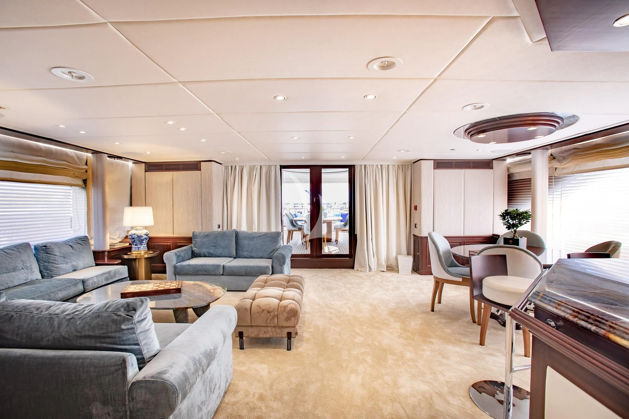 a living room with a piano and a piano aboard AKIRA ONE Yacht for Charter