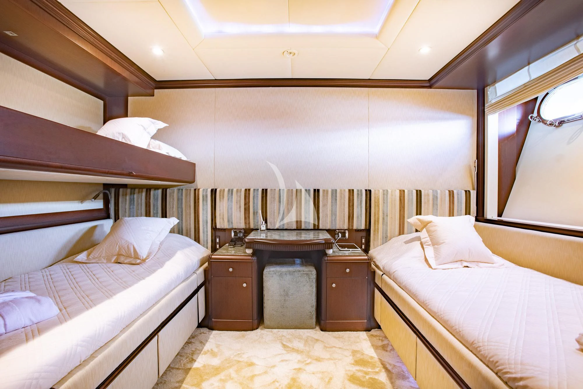 a room with a bed and a dresser aboard AKIRA ONE Yacht for Charter