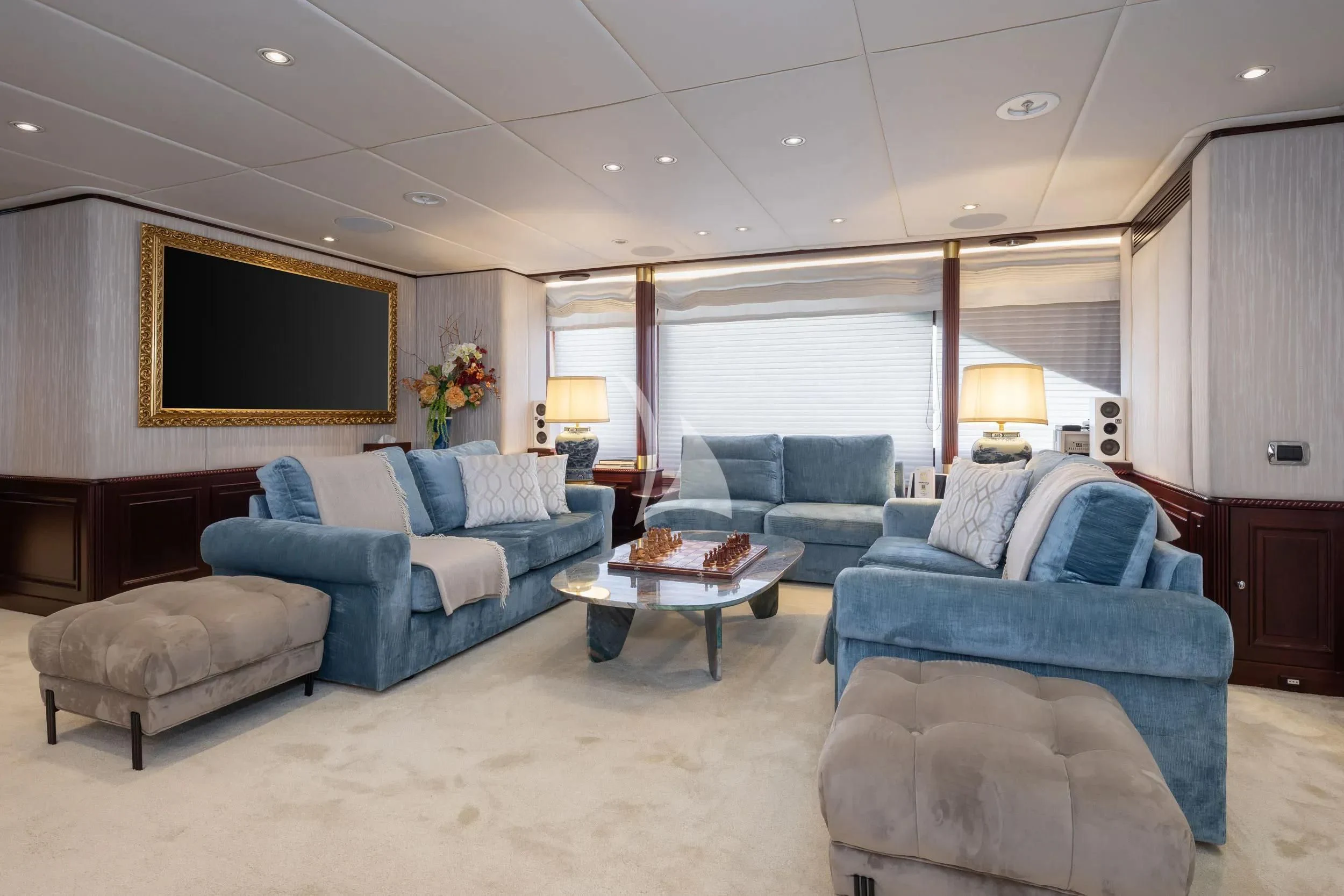 a living room with blue couches aboard AKIRA ONE Yacht for Charter