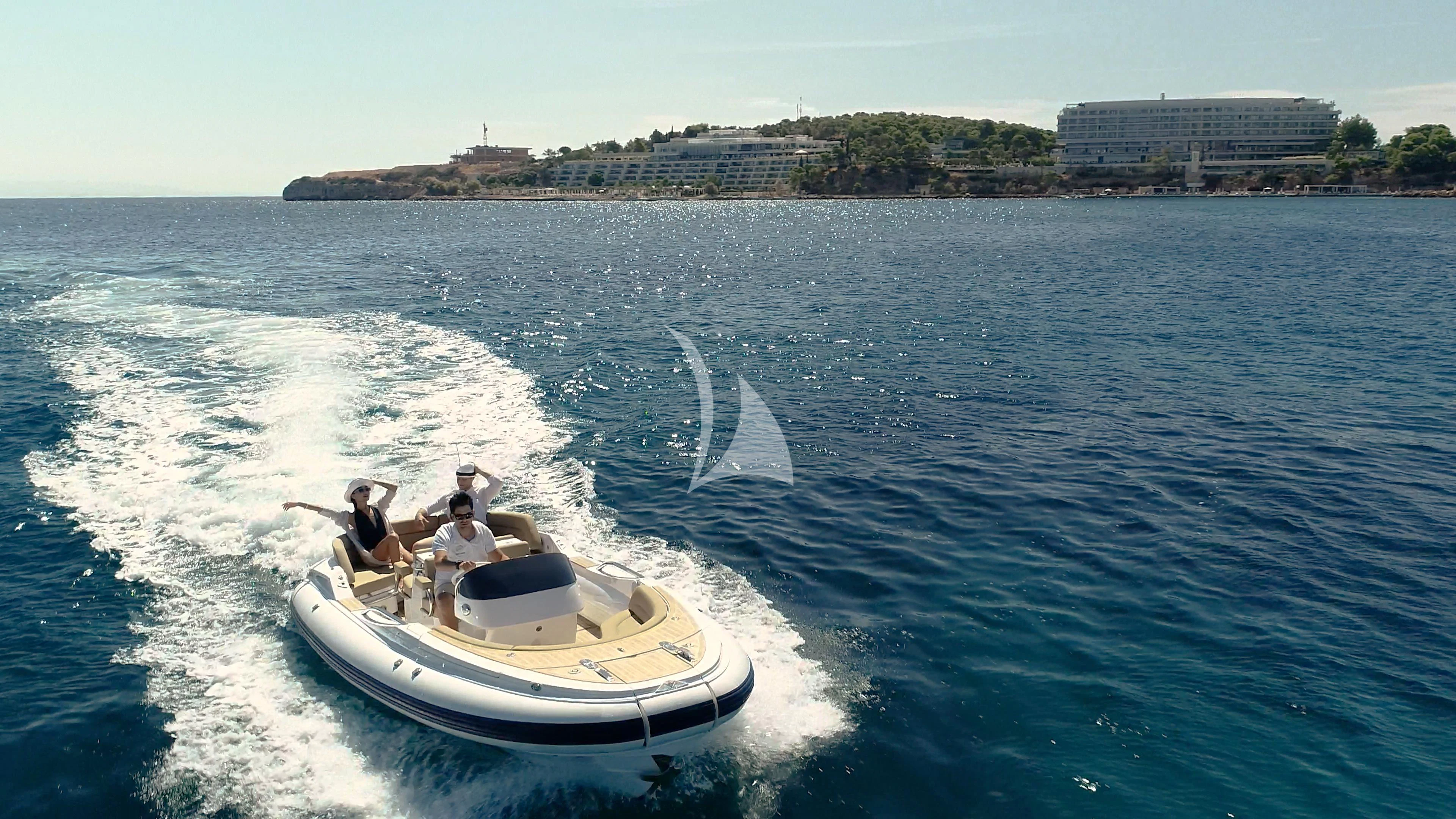 a couple of people in a speedboat on the water aboard AKIRA ONE Yacht for Charter