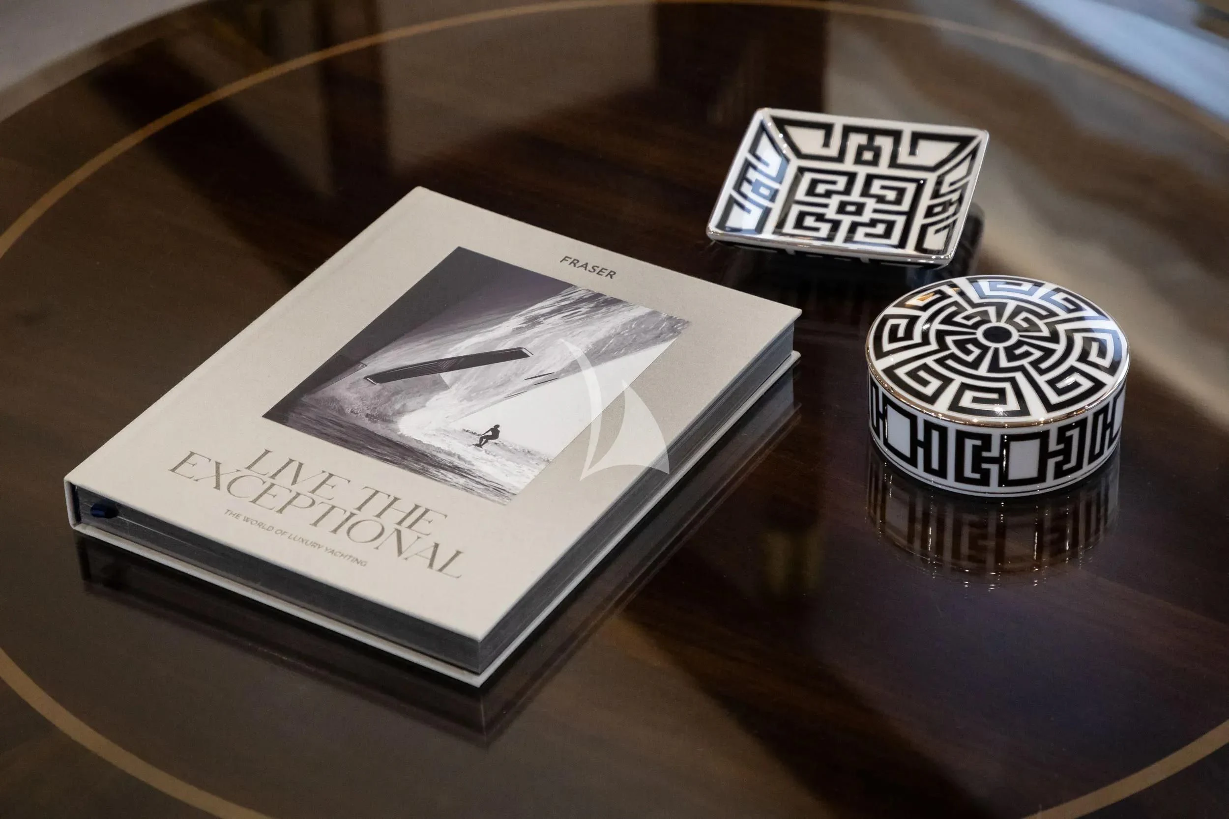 a glass of wine and a pack of cigarettes on a table aboard AKIRA ONE Yacht for Charter