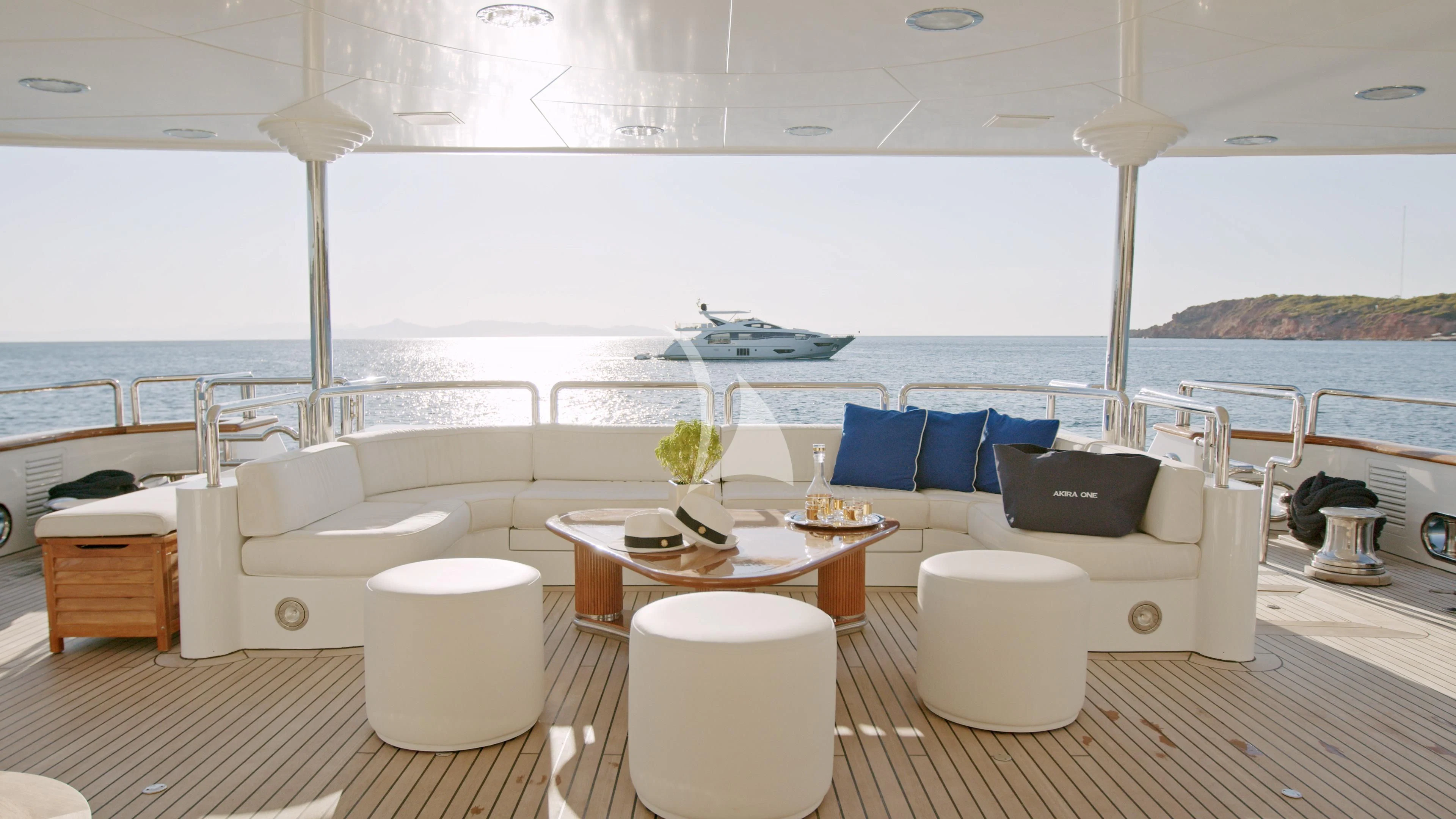 a room with a couch and a table and a large window aboard AKIRA ONE Yacht for Charter